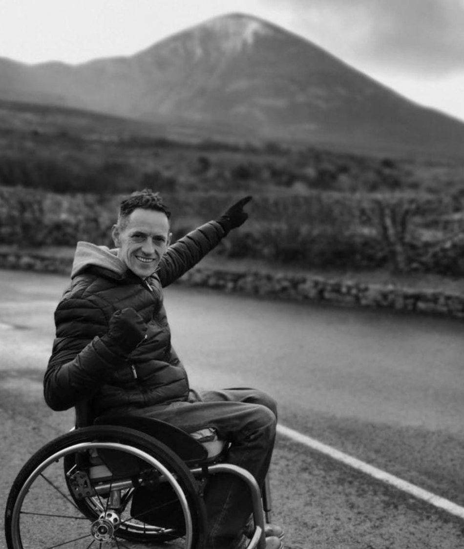 Lester Cassidy in his wheelchair with Croagh Patrick behind him